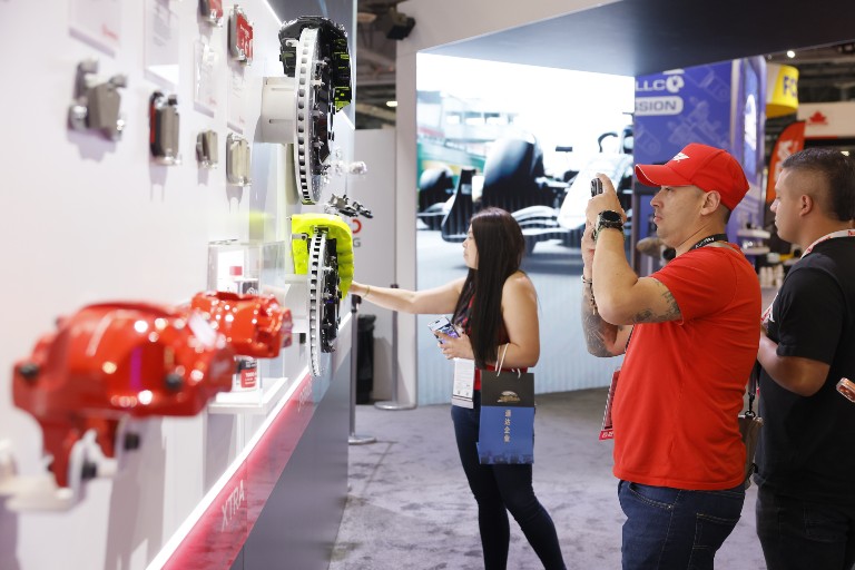 Buyers examining parts at AAPEX 2025.